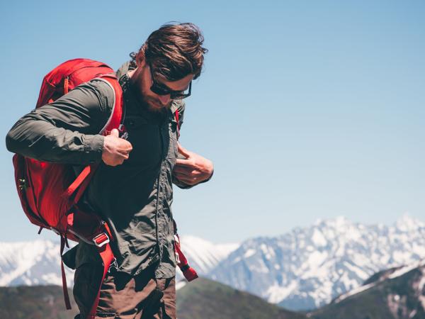 Man backpacking in mountains