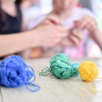 Adult and child knitting