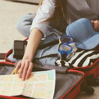 Woman packing suitcase for vacation